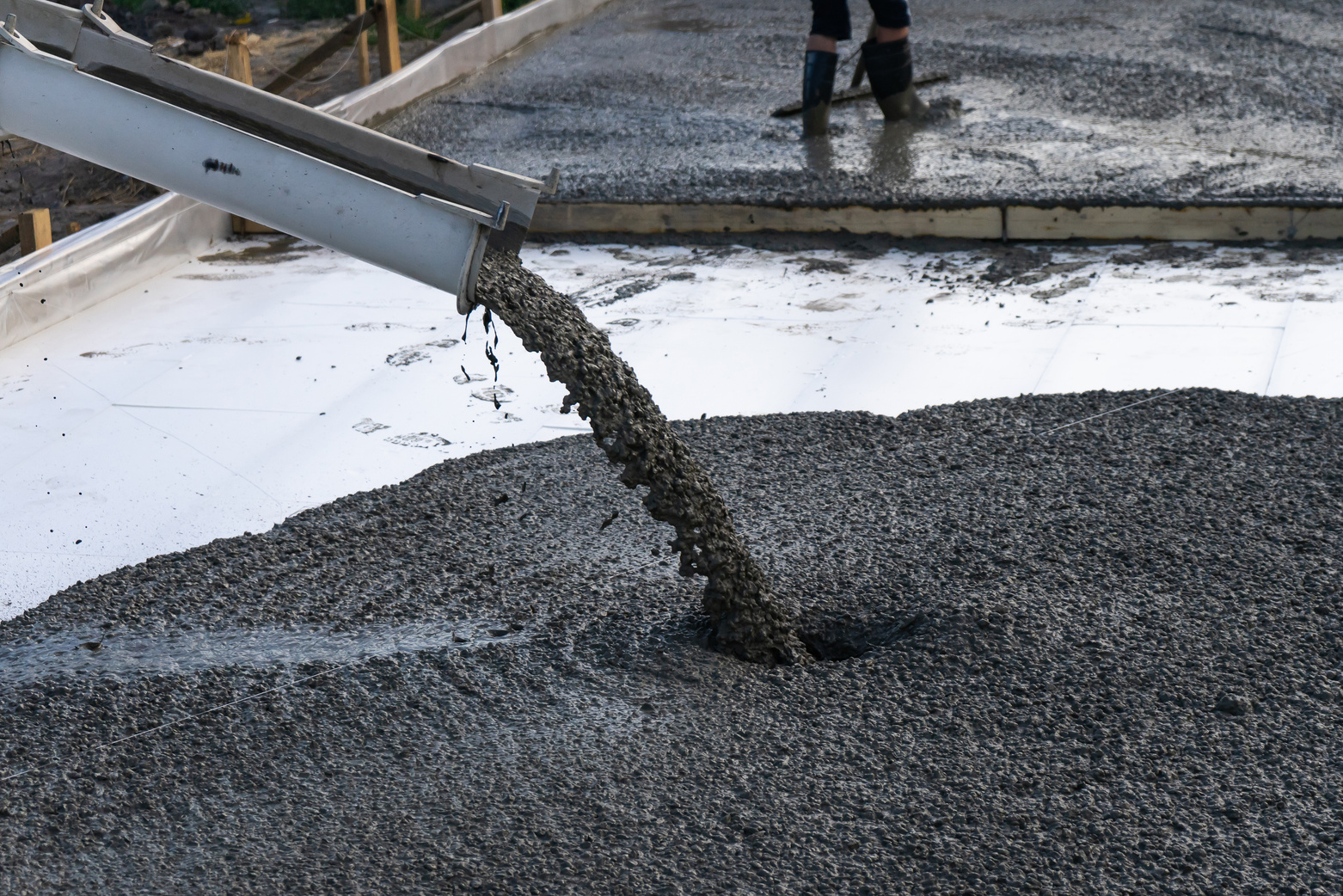 Workers pour the Foundation for the construction of a residential building using mobile concrete mixers.